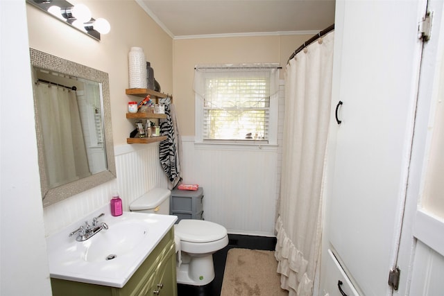 bathroom with ornamental molding, vanity, and toilet