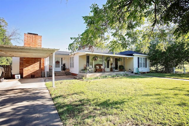 single story home featuring a carport, a porch, and a front lawn