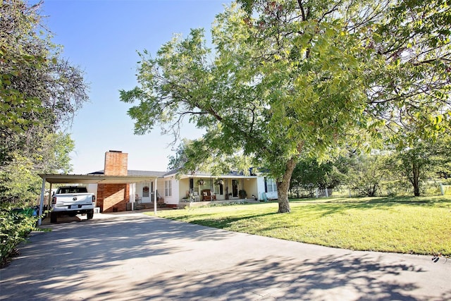 single story home with a front lawn and a carport