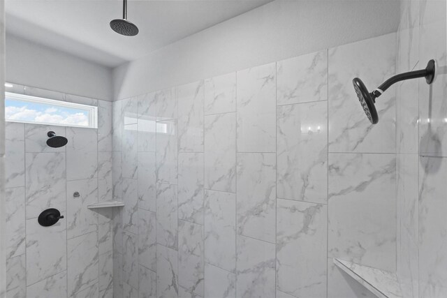 bathroom with tiled shower