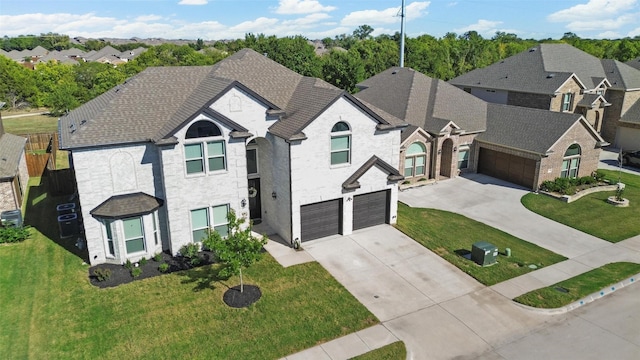 view of front of property with a residential view, central AC, a front yard, a garage, and driveway