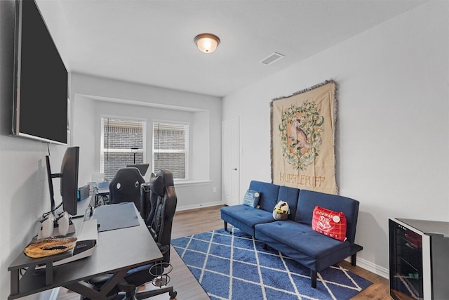 office featuring wine cooler and hardwood / wood-style floors