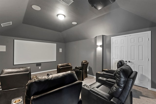 home theater room with lofted ceiling and carpet