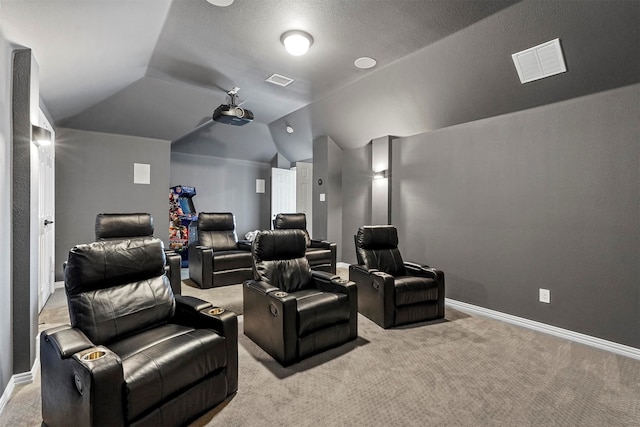 home theater with light colored carpet and vaulted ceiling