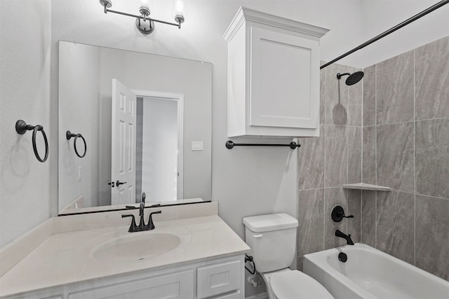 full bathroom with toilet, tiled shower / bath combo, and vanity