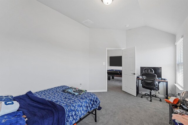 bedroom featuring lofted ceiling and light carpet