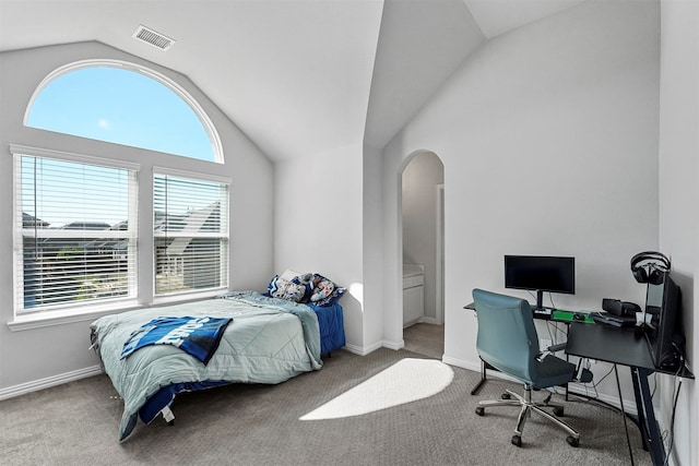 carpeted bedroom with vaulted ceiling