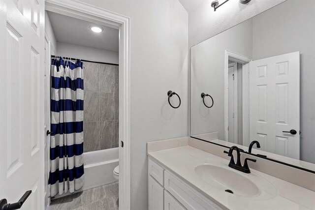 full bathroom featuring vanity, toilet, and shower / bath combo with shower curtain