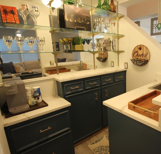 interior space featuring dark cabinets and light stone countertops