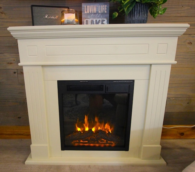 room details featuring a lit fireplace and wood finished floors