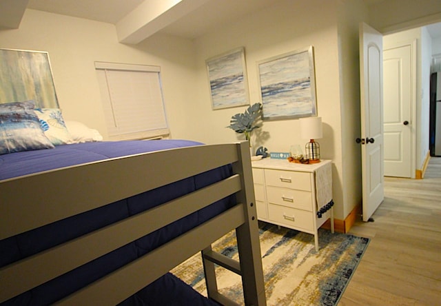 bedroom with baseboards and light wood-style flooring
