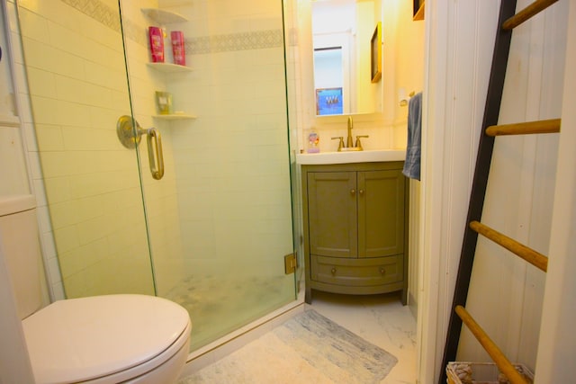 full bathroom with vanity, toilet, marble finish floor, and a stall shower