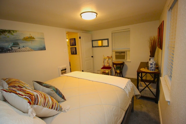 bedroom with carpet flooring, heating unit, and cooling unit