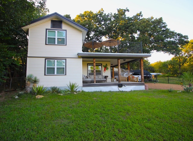 rear view of property with a yard, a patio, and fence