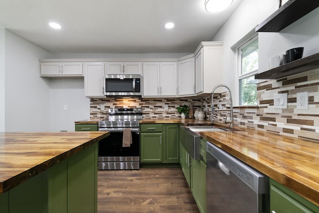 kitchen featuring white cabinetry, green cabinets, stainless steel appliances, and wooden counters