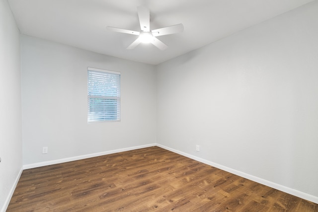 unfurnished room featuring ceiling fan and dark wood-type flooring