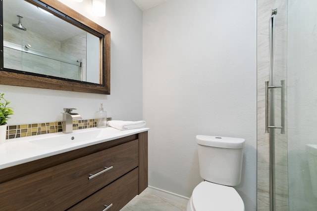 bathroom featuring vanity, toilet, and a shower with door