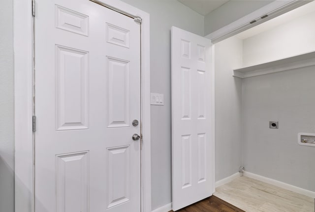 washroom with dark hardwood / wood-style floors and hookup for an electric dryer