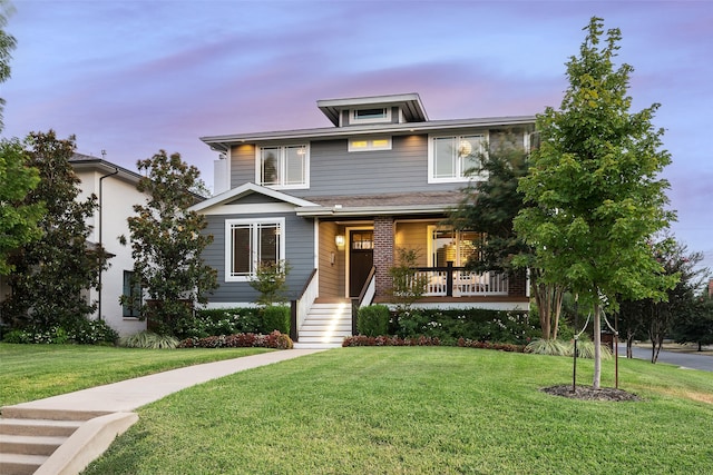 view of front of home featuring a porch and a yard