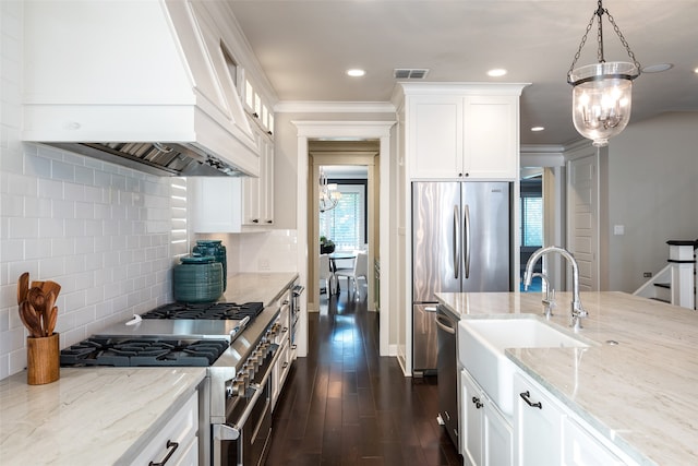 kitchen with custom exhaust hood, stainless steel appliances, dark wood-type flooring, decorative light fixtures, and white cabinets