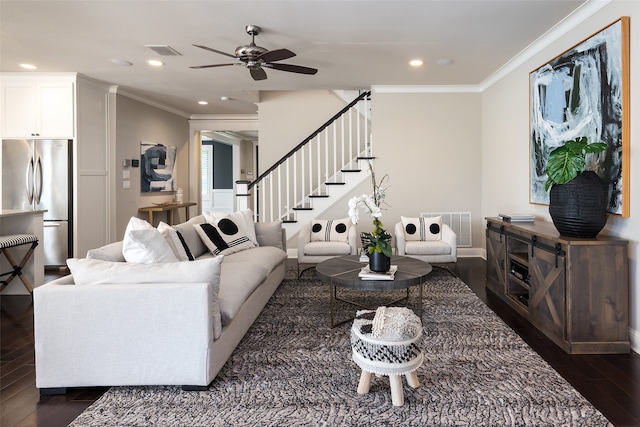 living room featuring dark hardwood / wood-style flooring, ceiling fan, and ornamental molding