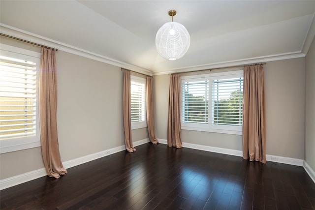 empty room with dark hardwood / wood-style floors and ornamental molding