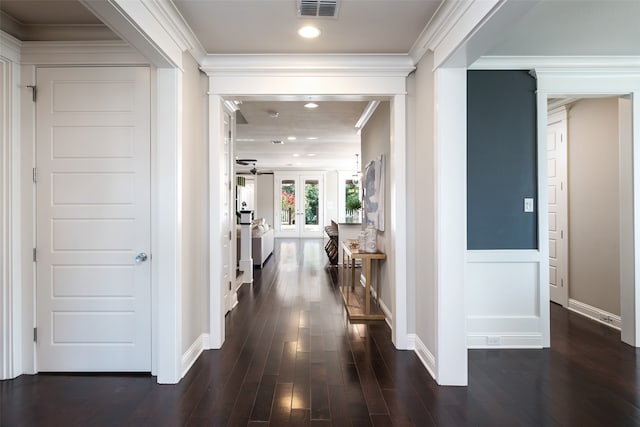 hallway featuring ornamental molding and dark wood-type flooring