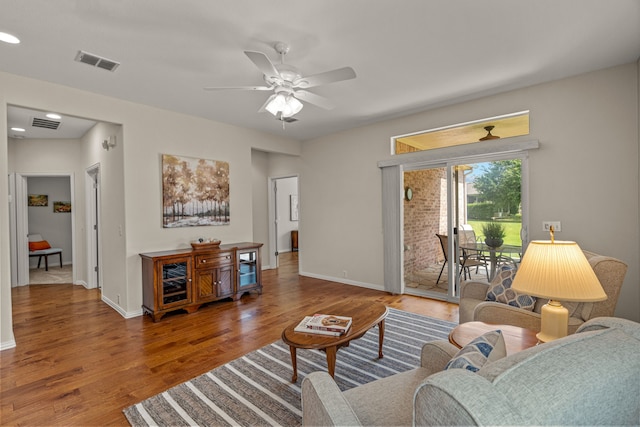 living room featuring hardwood / wood-style floors and ceiling fan