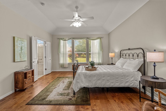 bedroom featuring connected bathroom, ceiling fan, and dark wood-type flooring