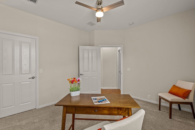 carpeted office space with ceiling fan