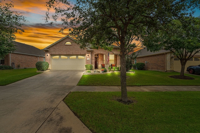 view of front of house featuring a garage and a lawn