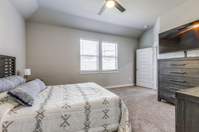 carpeted bedroom featuring lofted ceiling and ceiling fan