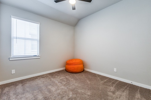 carpeted empty room with vaulted ceiling and ceiling fan