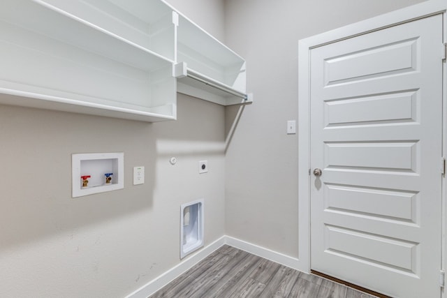 laundry area featuring light hardwood / wood-style floors, hookup for a washing machine, hookup for a gas dryer, and electric dryer hookup