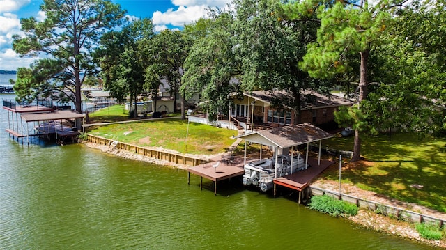 view of dock with a lawn and a water view