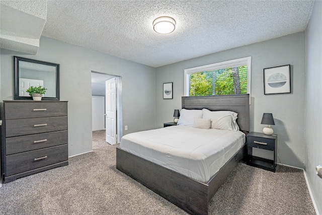 carpeted bedroom with a textured ceiling