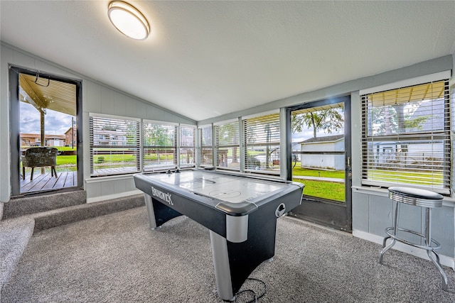 game room with carpet floors, a textured ceiling, lofted ceiling, and a wealth of natural light