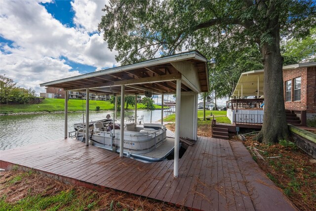 wooden deck with a lawn and a water view