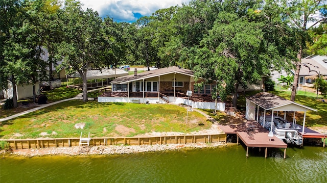 rear view of house with a lawn and a water view