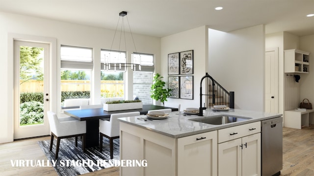 kitchen featuring light wood-type flooring, a kitchen island with sink, white cabinetry, dishwasher, and sink