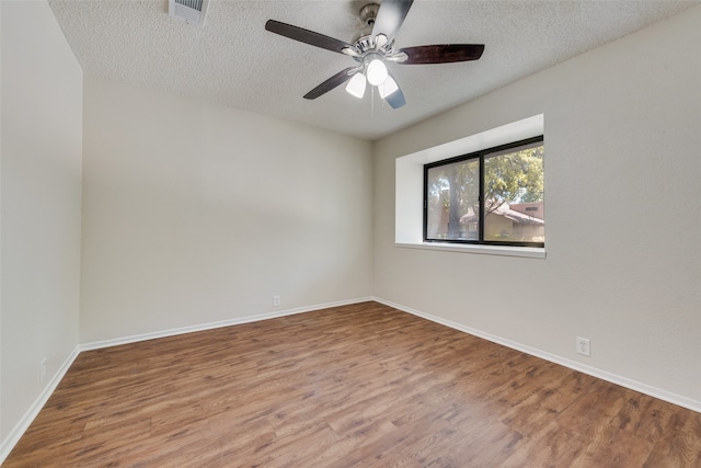 empty room with hardwood / wood-style floors, ceiling fan, and a textured ceiling