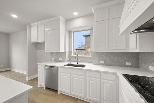 kitchen featuring white cabinetry, sink, light wood-type flooring, and dishwasher