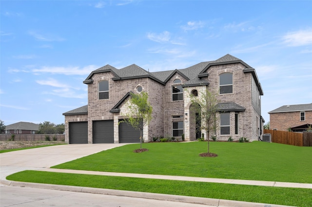 french country style house with central AC unit, a garage, and a front yard