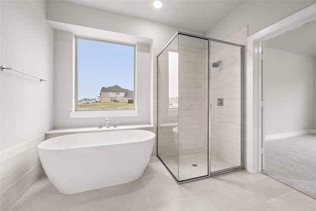 bathroom with independent shower and bath and tile patterned flooring