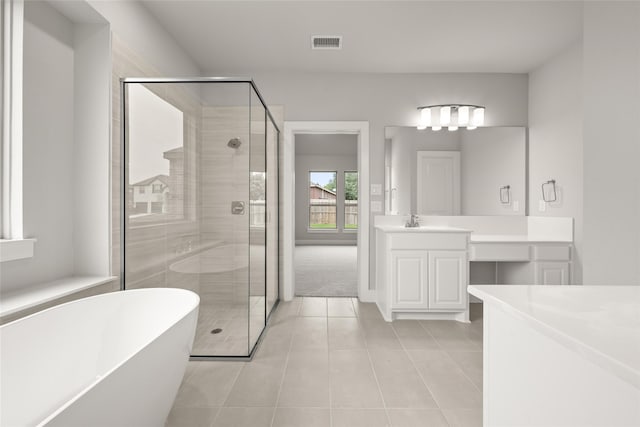 bathroom featuring vanity, tile patterned floors, and separate shower and tub