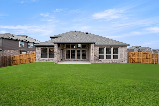 back of property featuring a yard and a patio