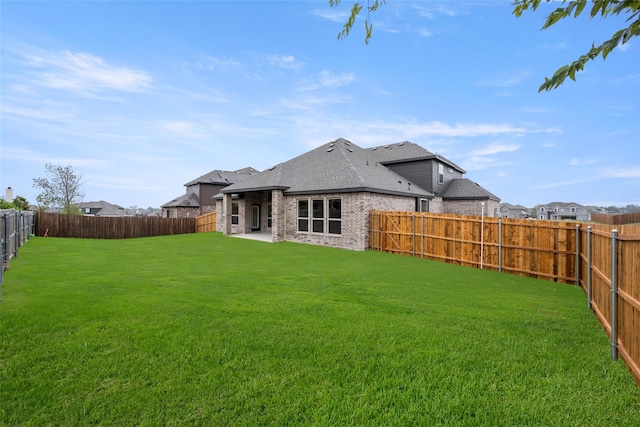 back of property with a lawn and a patio area