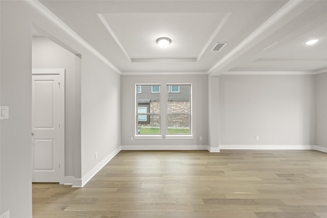 empty room with light hardwood / wood-style flooring and crown molding