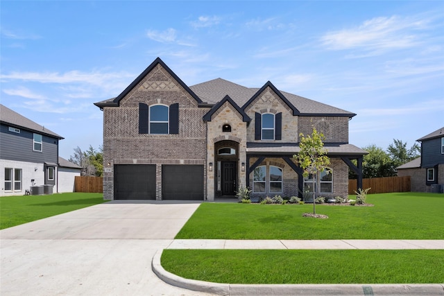 french country inspired facade with central AC, a front lawn, and a garage