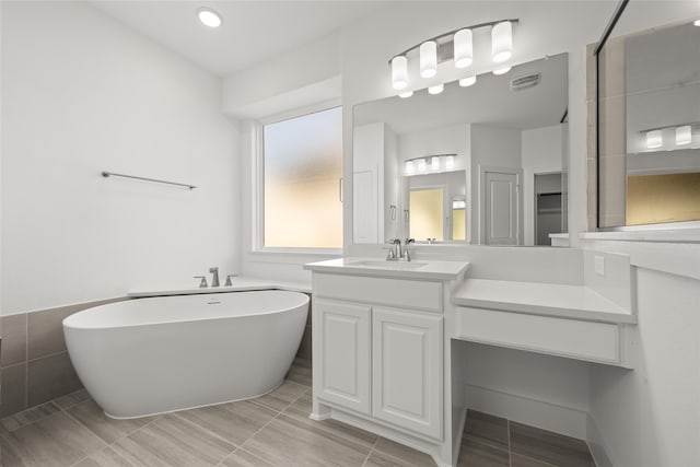 bathroom with a bathing tub and vanity